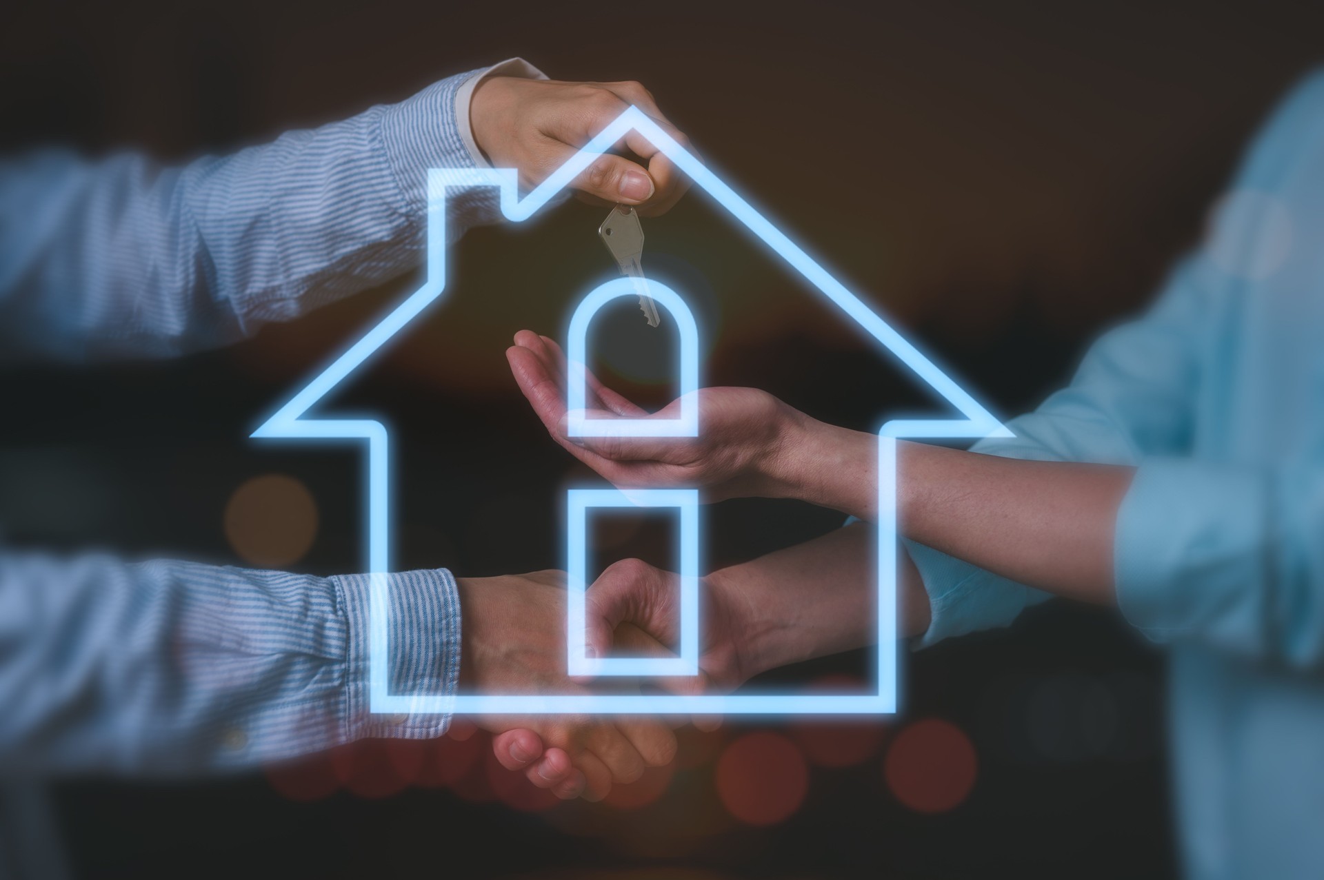 Two men handover a house key to buyer and doing handshake in concept of real estate agent property and investment, happy man talking with real estate agent and buying a new house